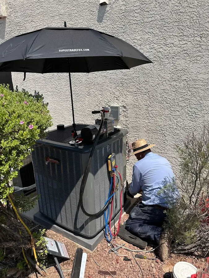 HVAC technician performing outdoor AC maintenance in Niagara Falls